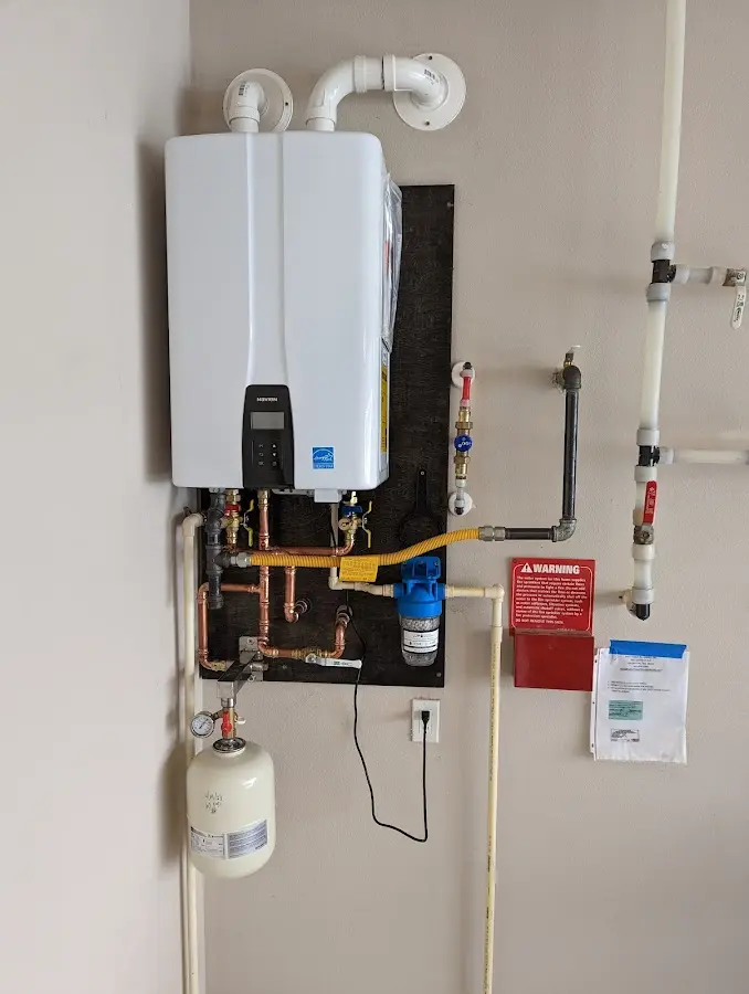 Professional plumber installing copper piping in a Ringgold home